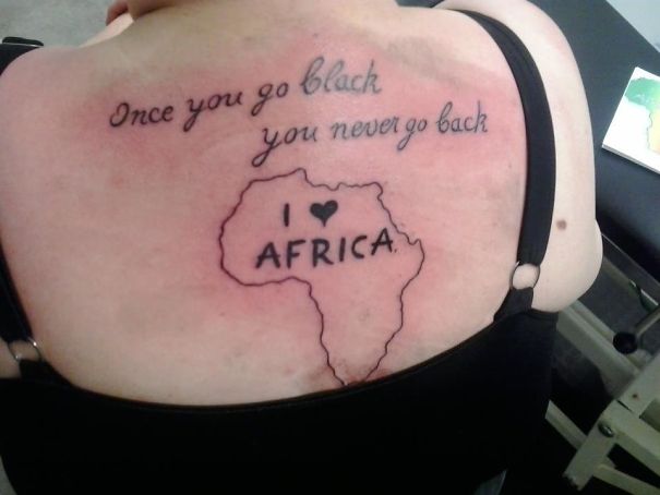 Back tattoo fail with African map and humorous text.