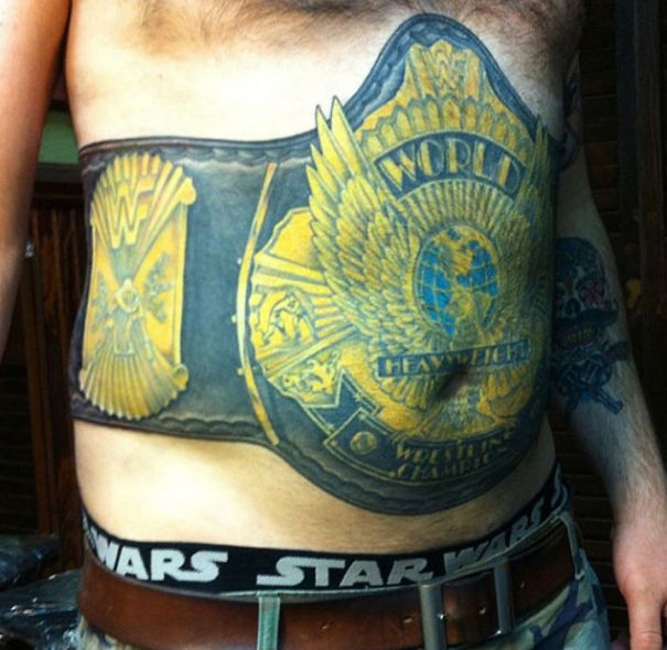 A bad tattoo fail depicting a championship belt design on a man's torso, with humorous Star Wars boxers visible.