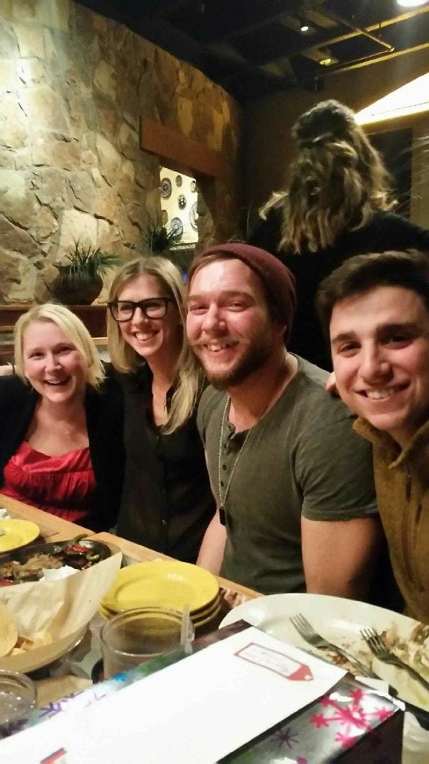 A Lady's Hairdo In The Background Makes It Look Like Chewbacca Is Lurking