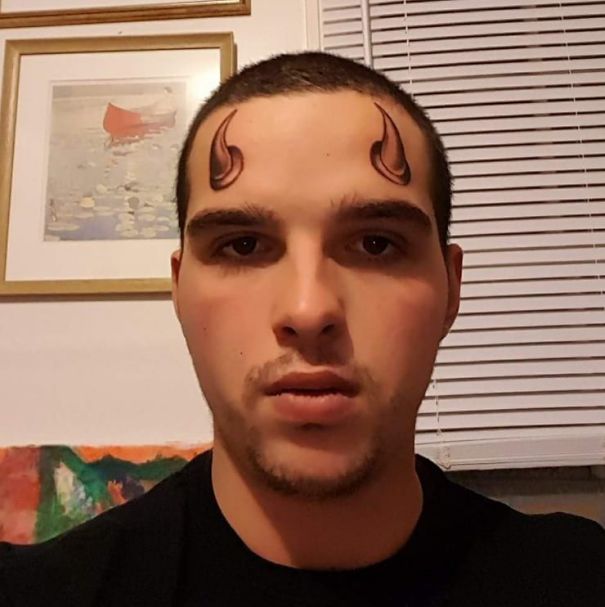 Man with unusual tattoo fails, featuring devil horn designs on his forehead, creating a humorous and cringeworthy look.