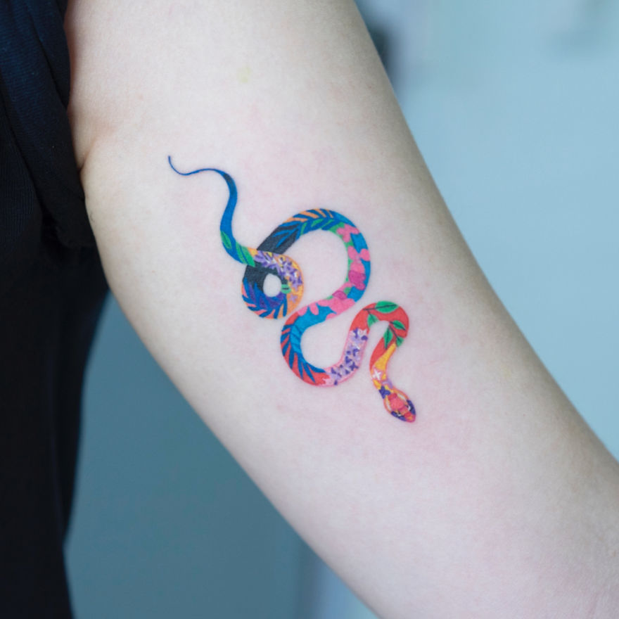 Colorful snake tattoo on arm by a Korean artist, featuring a unique blend of patterns and colors.