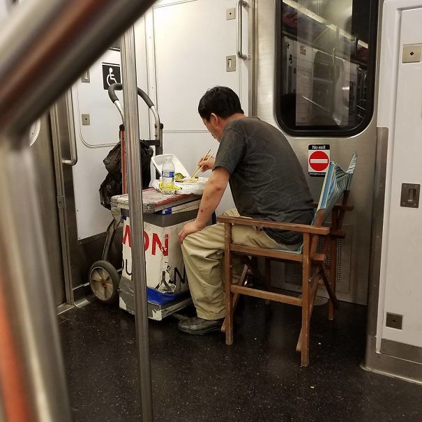 Sh*t You See On The 7 Train, On My Way Home... Homie Truly Got A Defacto Table Set Up, With A Chair To Boot, Eating A Meal... NYC Transit For You!