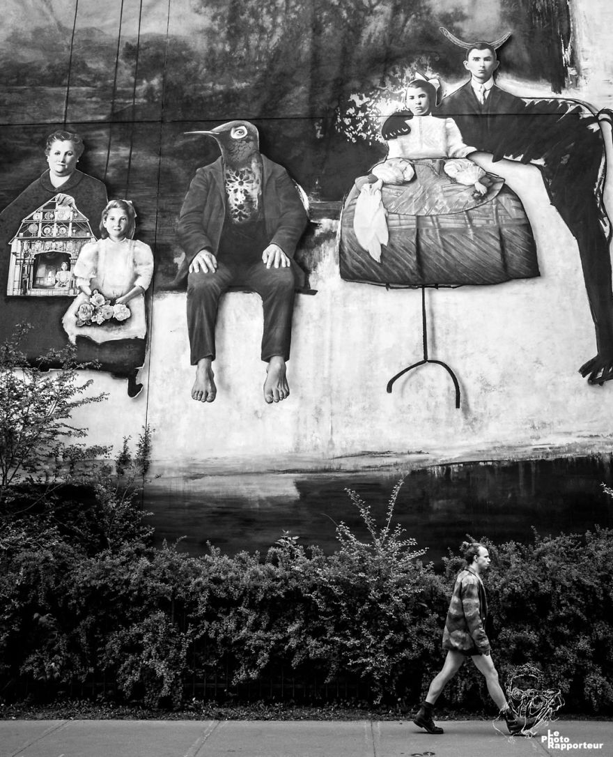 On Saturday, May 19th 2018 At 12:58pm, A Man In Very Short Shorts Walked By A Strange Mural Making Quite Long Strides