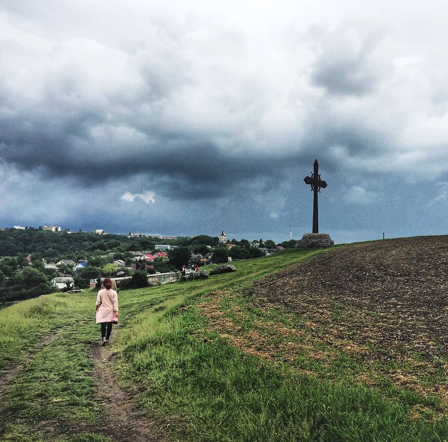 In The Shot: An Epic Journey To The Huge Cross On The Edge Of The Mountain. Behind The Scene: Getting Wet From The Rain And Being Afraid Of The Cows On My Left, Cows On My Right And Cows Behind The Photographer. (That's Ukraine, Btw)