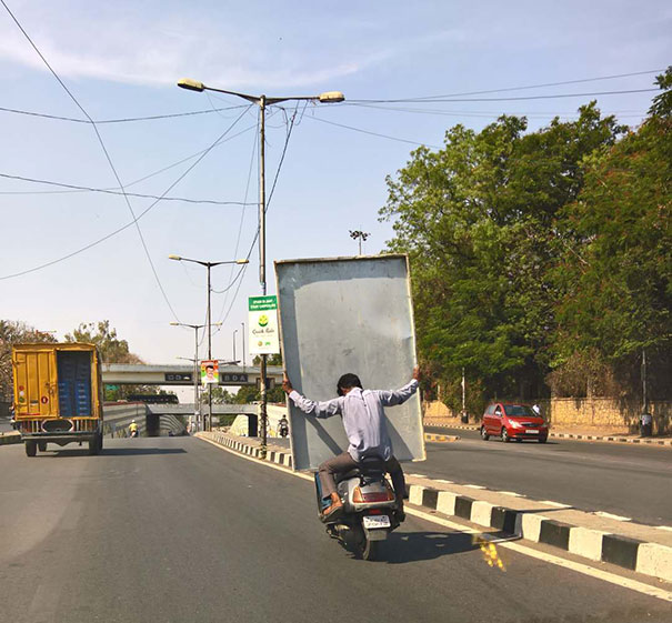 Umm. Not Sure Which Is Worse, The Guy Transporting Sheet Metal On The Scooter, Or The Unsecured Load In The Truck