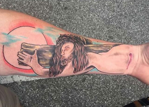 Bad tattoo fail on forearm featuring a creative design gone wrong with unusual placement and perspective.