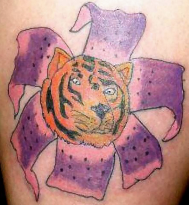 Bad tattoo fail featuring a tiger face with purple flower petals.