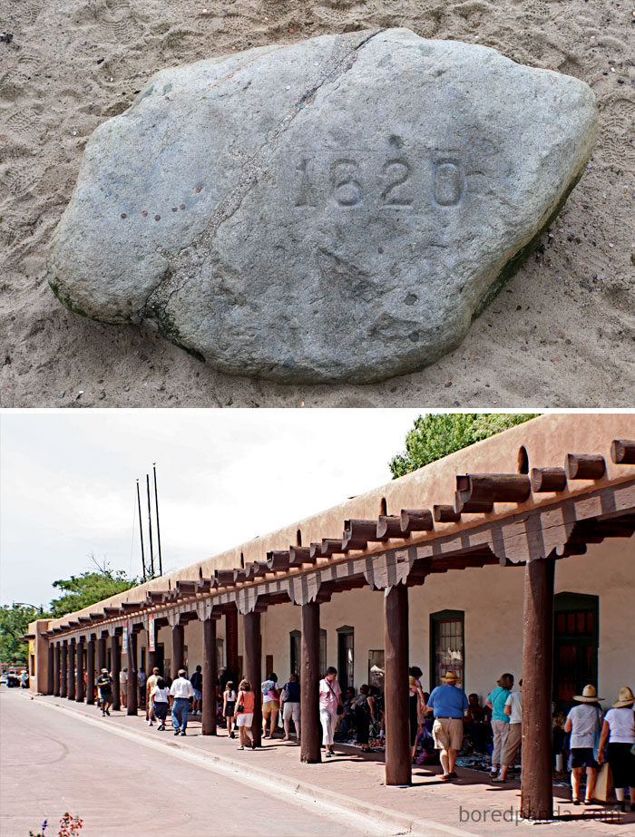A carved 1620 historic rock and a long adobe building with wooden beams visited by tourists exploring historical facts.