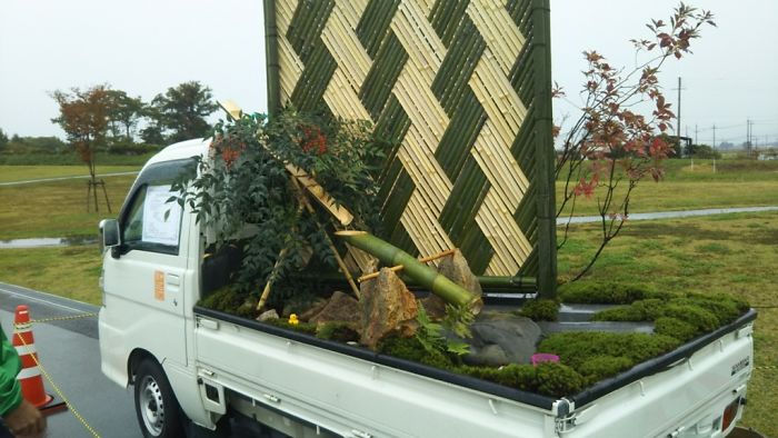 Garden With Flowing Water And Bamboo Pattern Wall