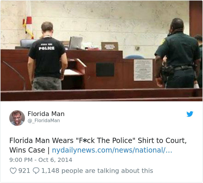 Florida man in court wearing a controversial shirt, standing beside a police officer.