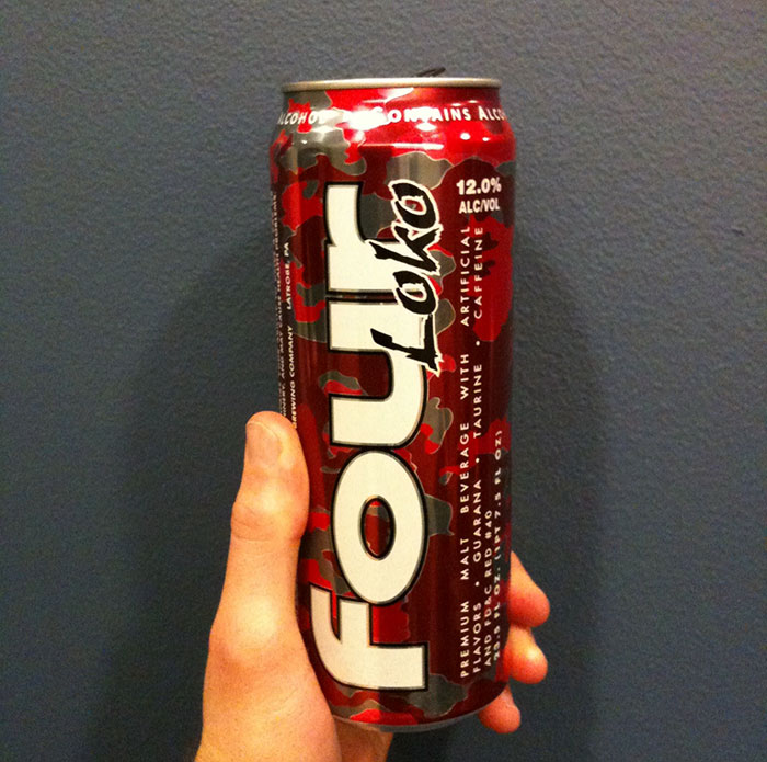 Person holding red Four Loko can