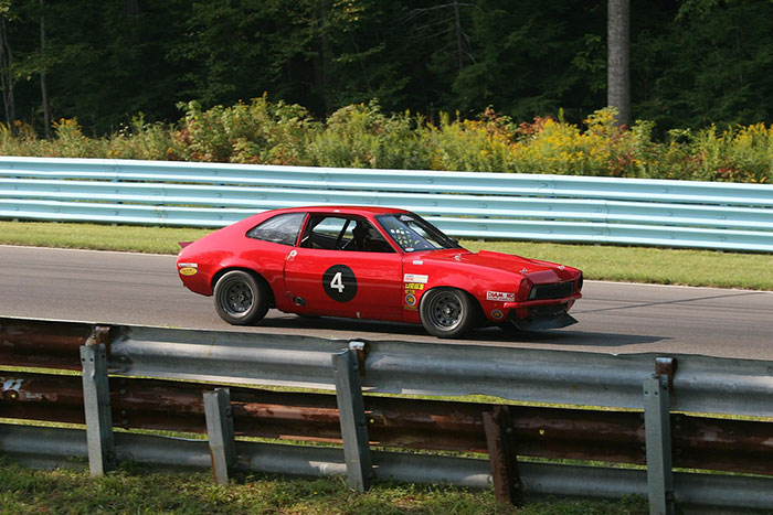 Red Pinto car on the road