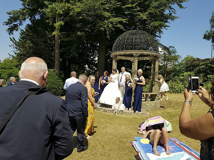 A wedding couple were left disgruntled when a shameless sunbather photobombed their wedding pictures by refusing to move. See story SWWEDDING. Newly-weds Mark Ling,49, and Mandy Cripwell, 35, were married in church on Saturday, and retired to a renowned beauty spot and public park to take what they hoped would be the perfect snaps. But their idyllic sun-kissed scene soon turned was ruined by a stubborn sunbather who had taken up residence on the green. The family of Torquay, Devon, say they asked the scantily-clad woman to move but she refused, and the wedding party were forced to pose for pictures around her. Mark's son, 24-year-old Marcus Ling, even approached the woman and asked her to move - but she pretended to be asleep. A wedding couple were left disgruntled when a shameless sunbather photobombed their wedding pictures by refusing to move. See story SWWEDDING. Newly-weds Mark Ling,49, and Mandy Cripwell, 35, were married in church on Saturday, and retired to a renowned beauty spot and public park to take what they hoped would be the perfect snaps. But their idyllic sun-kissed scene soon turned was ruined by a stubborn sunbather who had taken up residence on the green. The family of Torquay, Devon, say they asked the scantily-clad woman to move but she refused, and the wedding party were forced to pose for pictures around her. Mark's son, 24-year-old Marcus Ling, even approached the woman and asked her to move - but she pretended to be asleep.