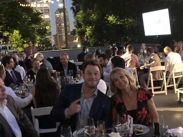 Funny dad making a playful face at an outdoor evening event.