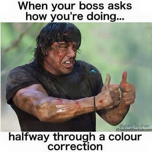 Man looking stressed with thumbs up, humorously capturing a hairstylist's struggle during color correction.