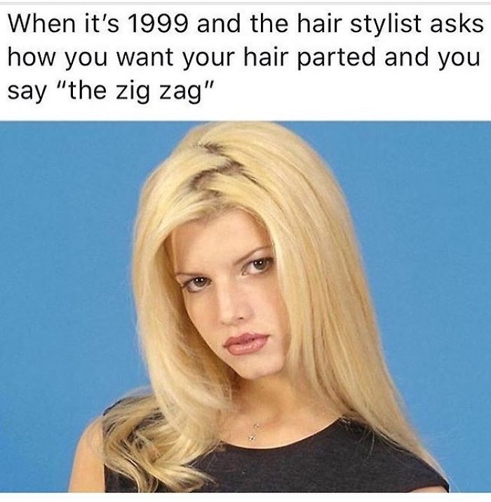 Blonde woman with a zigzag hair part, looking serious, captures a 1999 hair trend, evoking hairstylist challenges.