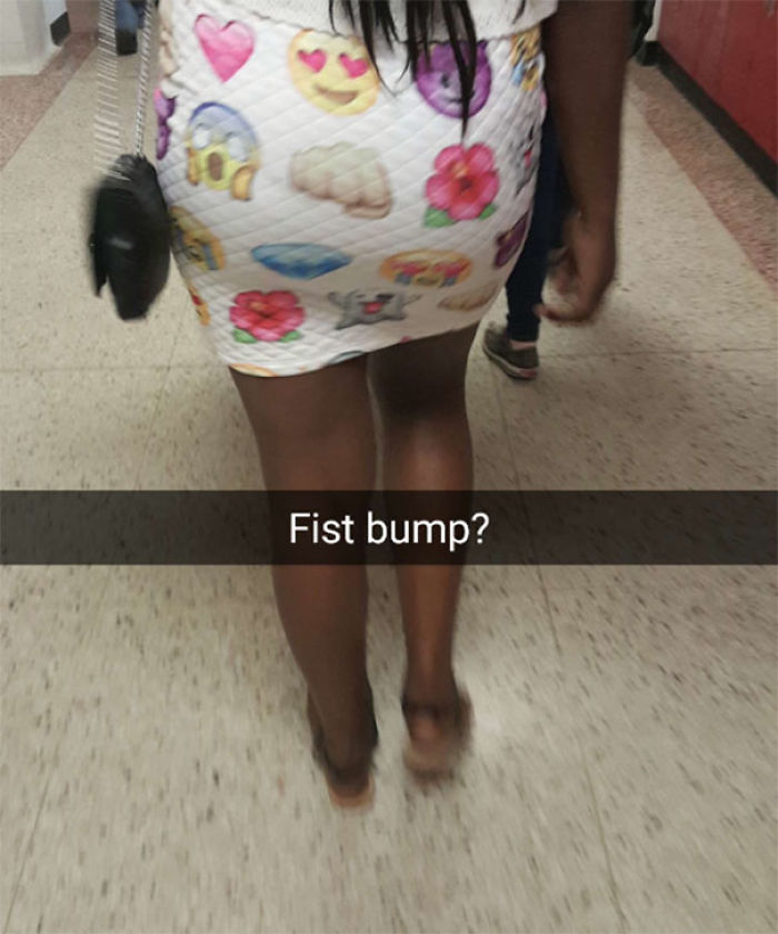 Woman wearing emoji-patterned skirt, showcasing one of the epic clothing disasters with a humorous twist.