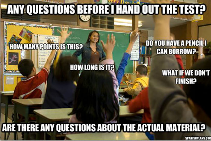 Teacher answering student questions in a classroom, highlighting educator challenges with humor.