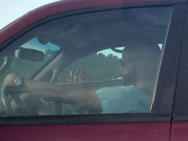 Looked Over In Completely Stopped Rush Hour Traffic To See This Guy Practicing His Trumpet. Sheet Music Spread Out On The Dash And Everything