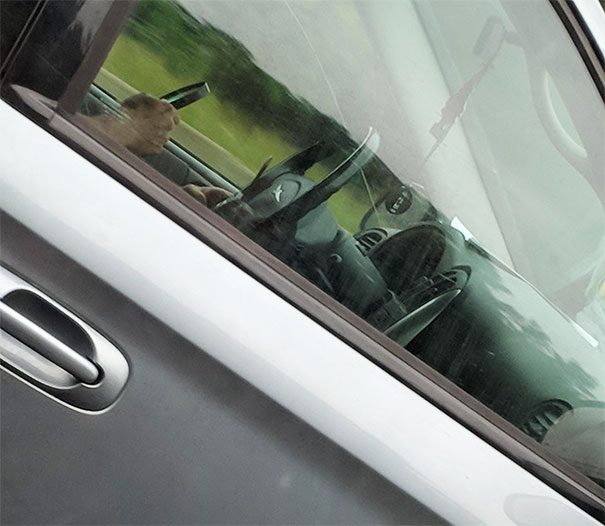 Using Magnifying Glass To Text On A Flip Phone On The Highway