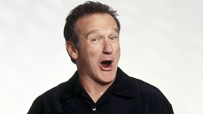 Robin Williams wearing black shirt laughing