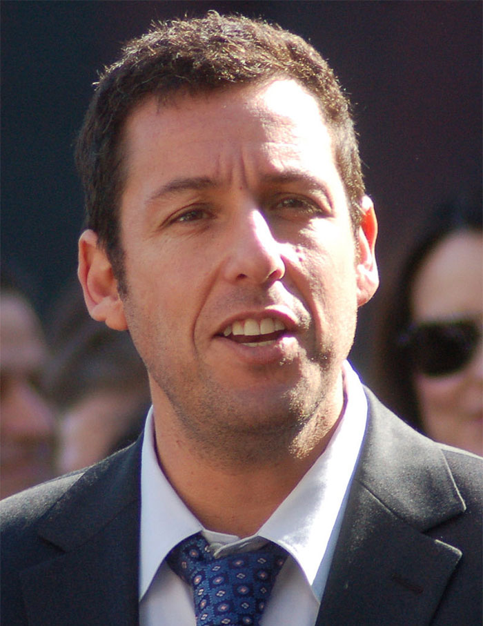 Adam Sandler wearing suit looking