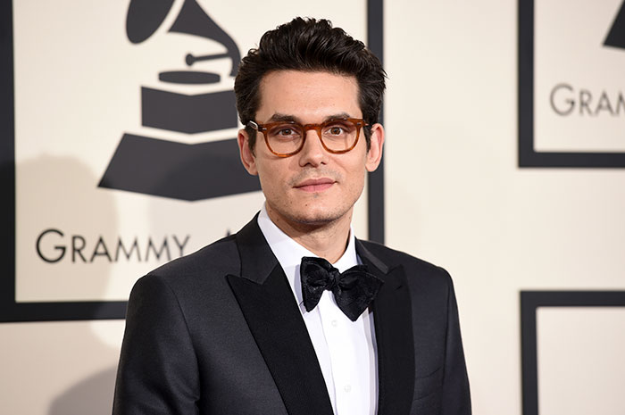 John Mayer wearing suit looking