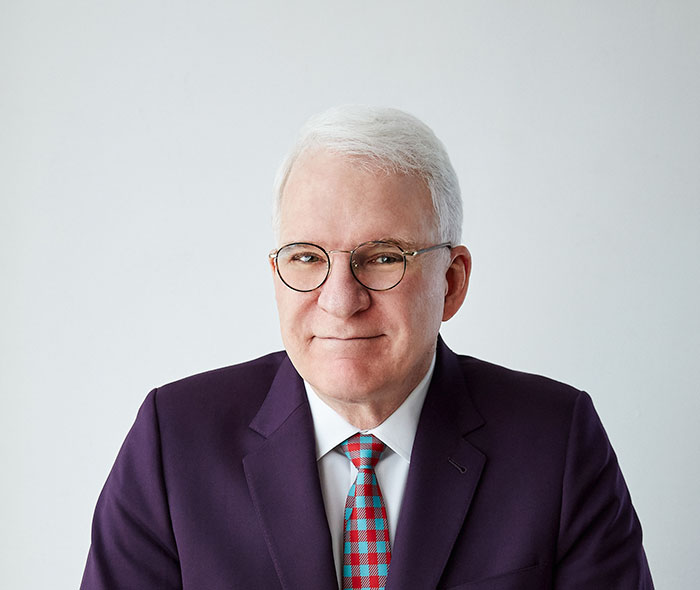 Steve Martin wearing suit and smiling