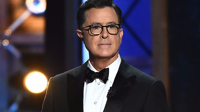 Stephen Colbert wearing suit and looking