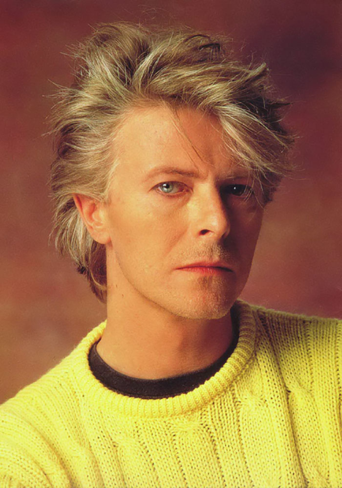 David Bowie wearing yellow sweater