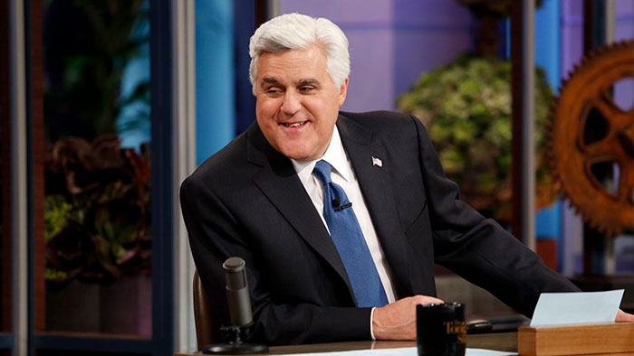 Jay Leno wearing suit and smiling