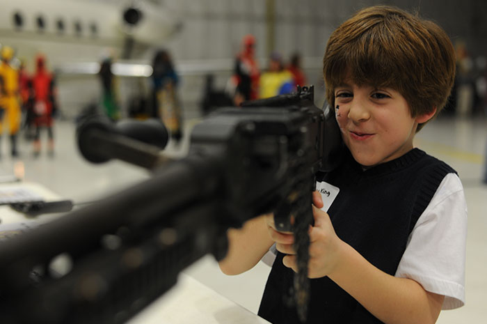Child playing with toy gun