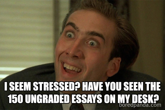 Educator stress meme shows a person humorously overwhelmed by 150 ungraded essays on their desk.