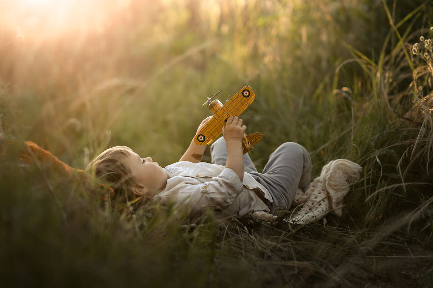 Niel, Belgium- A Boy Playing With A Plane On A Warm Summer Evening