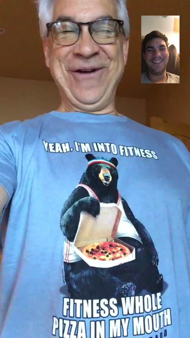Smiling dad wearing a funny fitness-themed T-shirt with a bear holding pizza.