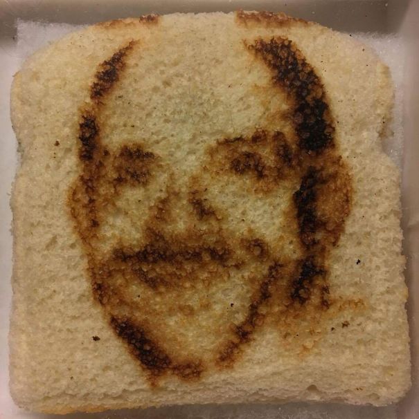 Funny dad's face humorously toasted on a slice of bread.