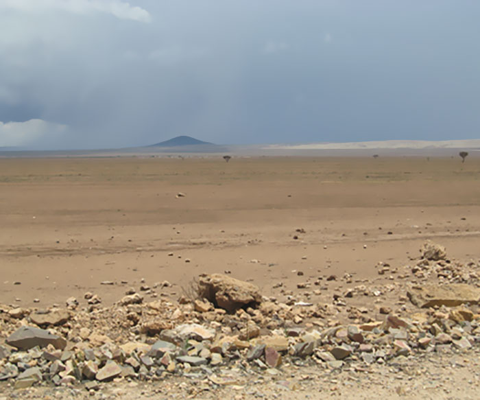 Barren rocky landscape under a cloudy sky illustrating potential future changes to Earth over the next trillion years.