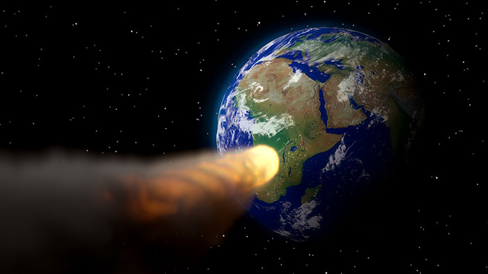 Asteroid heading toward Earth in space, illustrating possible events to happen to Earth in the next trillion years.