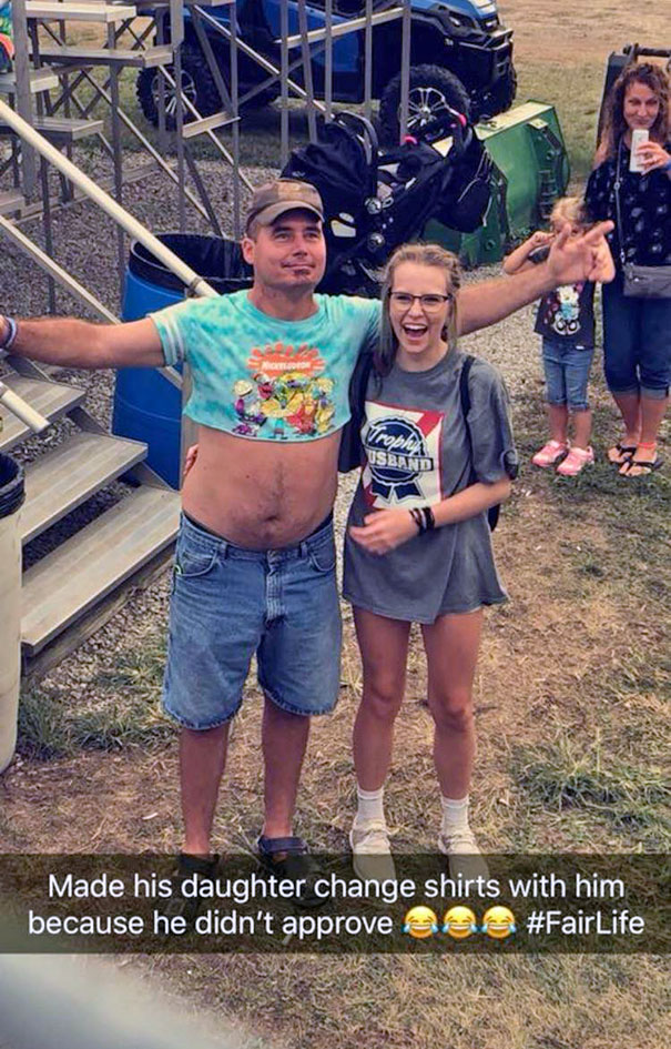 Funniest dad ever swaps shirts with daughter at outdoor event, making everyone laugh.