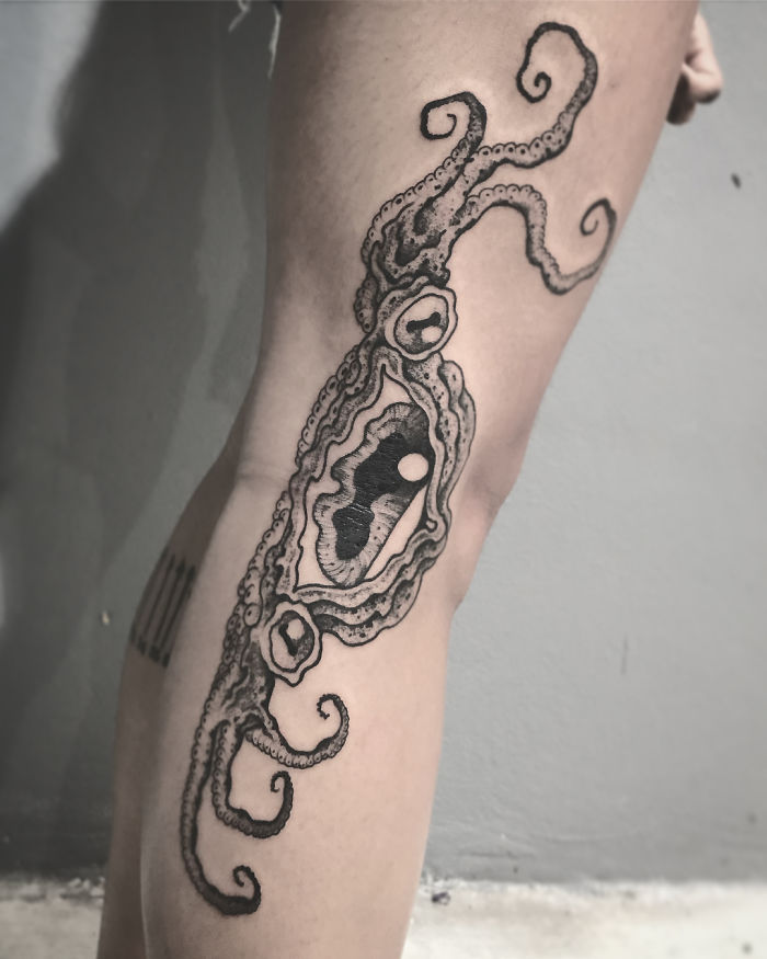 Octopus tattoo on a leg, revealing intricate designs when extended, showcasing body art creativity. Octopus tattoo on a leg, revealing intricate designs when extended, showcasing body art creativity.