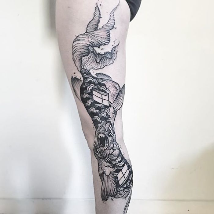 Leg tattoo with a detailed koi fish design, revealing intricate elements when the leg is extended. Leg tattoo with a detailed koi fish design, revealing intricate elements when the leg is extended.