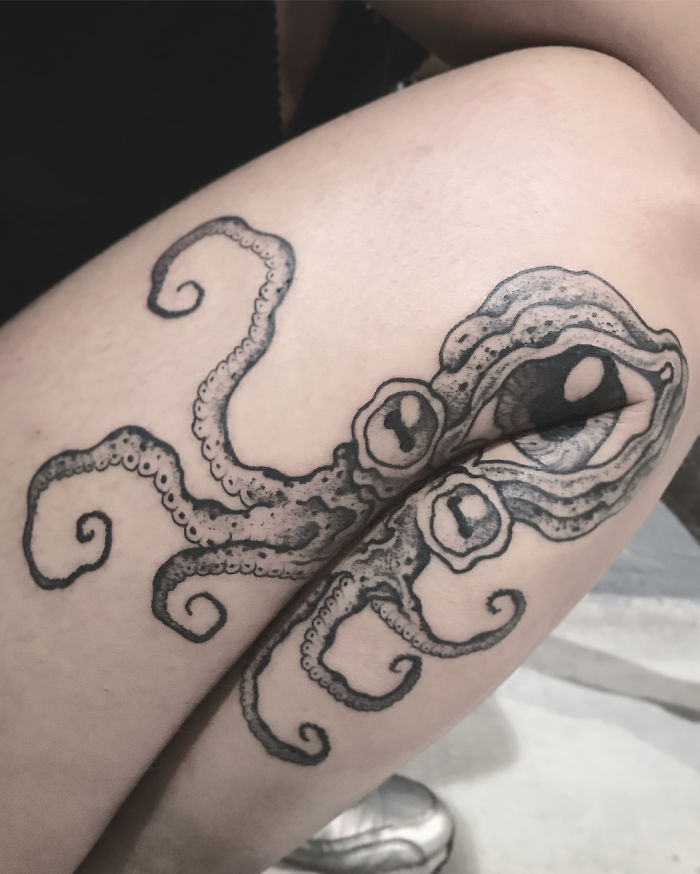 Octopus tattoo on a leg, extending with movement, revealing hidden details.