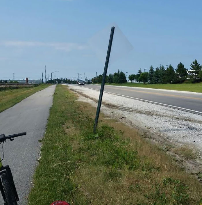 The Back Of This Sign Is Nearly Transparent Against The Color Of The Sky