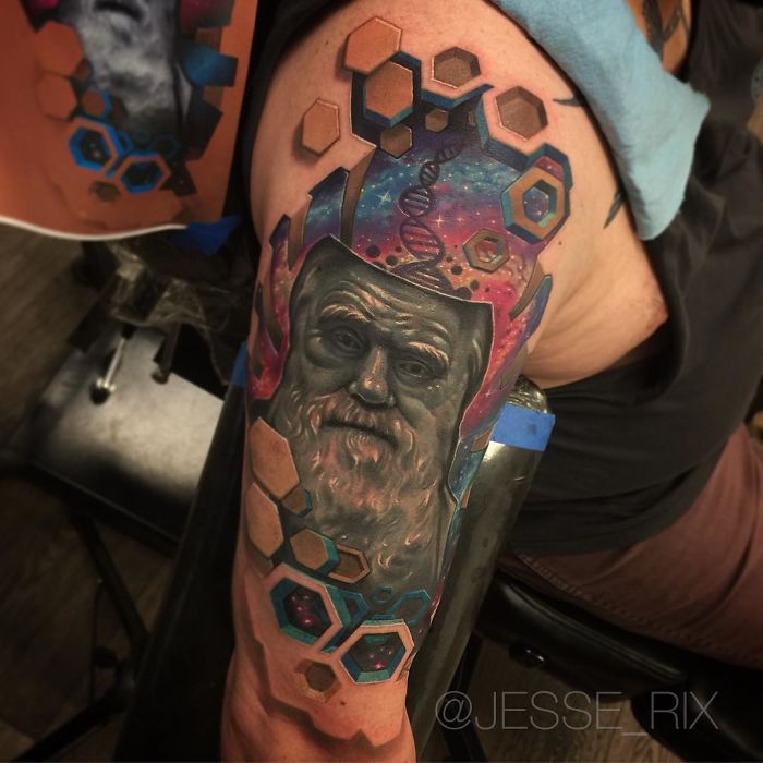 3D tattoo on arm featuring a detailed portrait with hexagonal geometric patterns and cosmic elements.