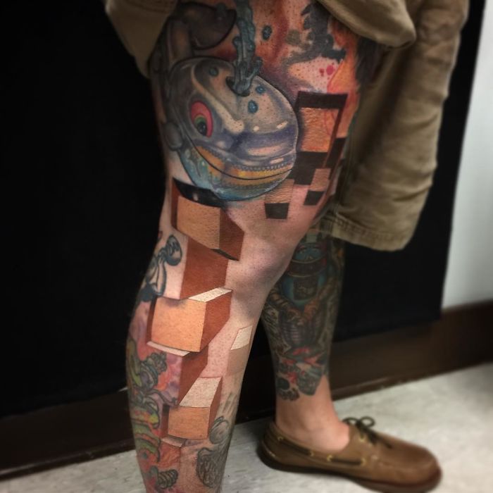 3D tattoo of cubes and a whale on a person's leg, showcasing artistic detail.