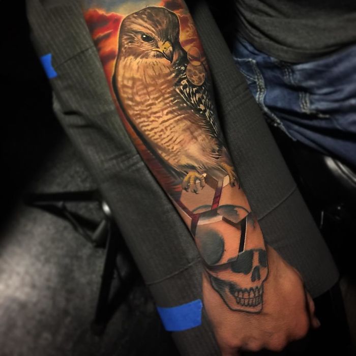 3D tattoo of a hawk and skull on arm, showcasing amazing artistic detail and realism.