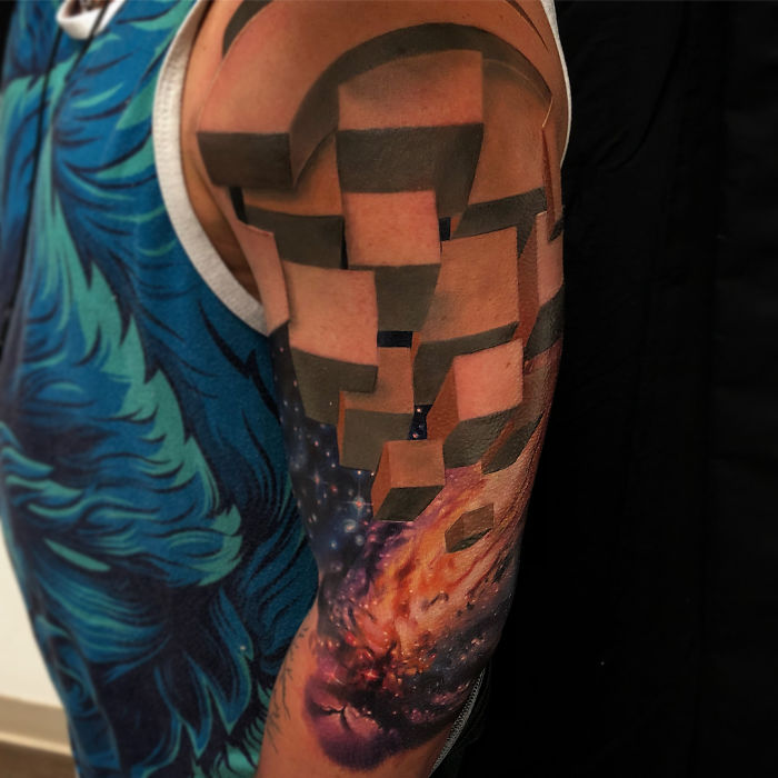 3D tattoo on arm with abstract geometric blocks and cosmic design, creating an impressive visual effect.