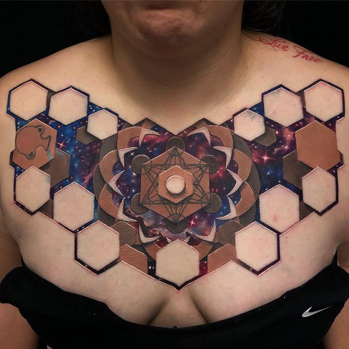 3D tattoo on a person's chest featuring geometric patterns and galaxy elements.