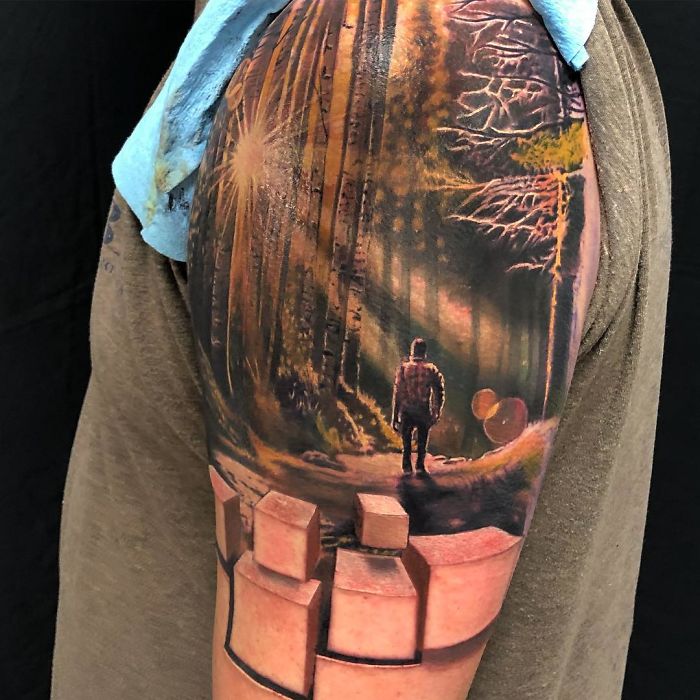 3D tattoo of a forest scene with a person walking, featuring light beams and blocks creating a stunning optical illusion.