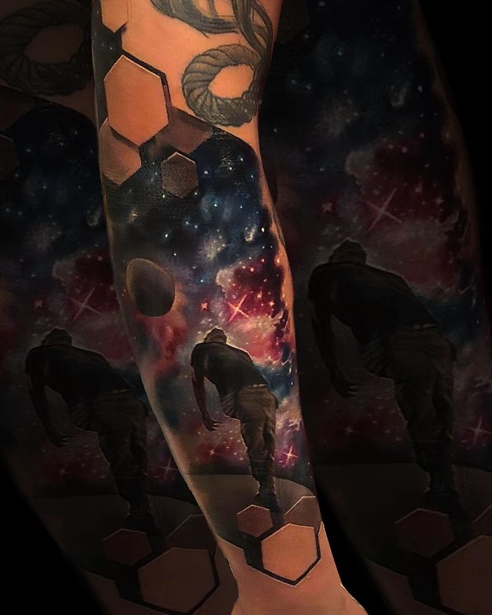3D tattoo with cosmic design and hexagons on an arm, creating an optical illusion that captivates the viewer.